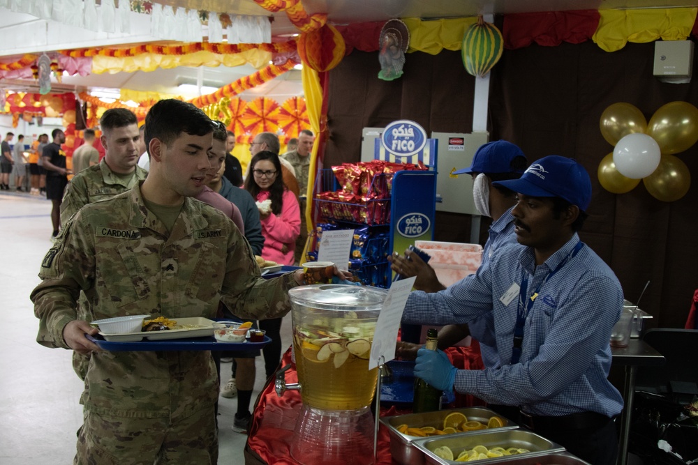 Soldiers stand in line for Thanksgiving meal at Camp Arifjan