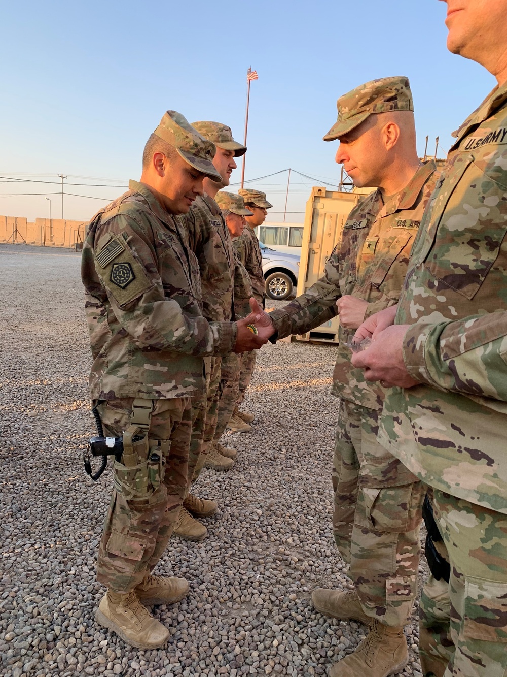 DVIDS - Images - Brig. Gen. Howard Geck, commander of the 103rd Sustainment  Command (Expeditionary), presents his commander's coin [Image 4 of 6]