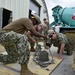 U.S. Navy Seabees with NMCB-5 place concrete at Camp Shields