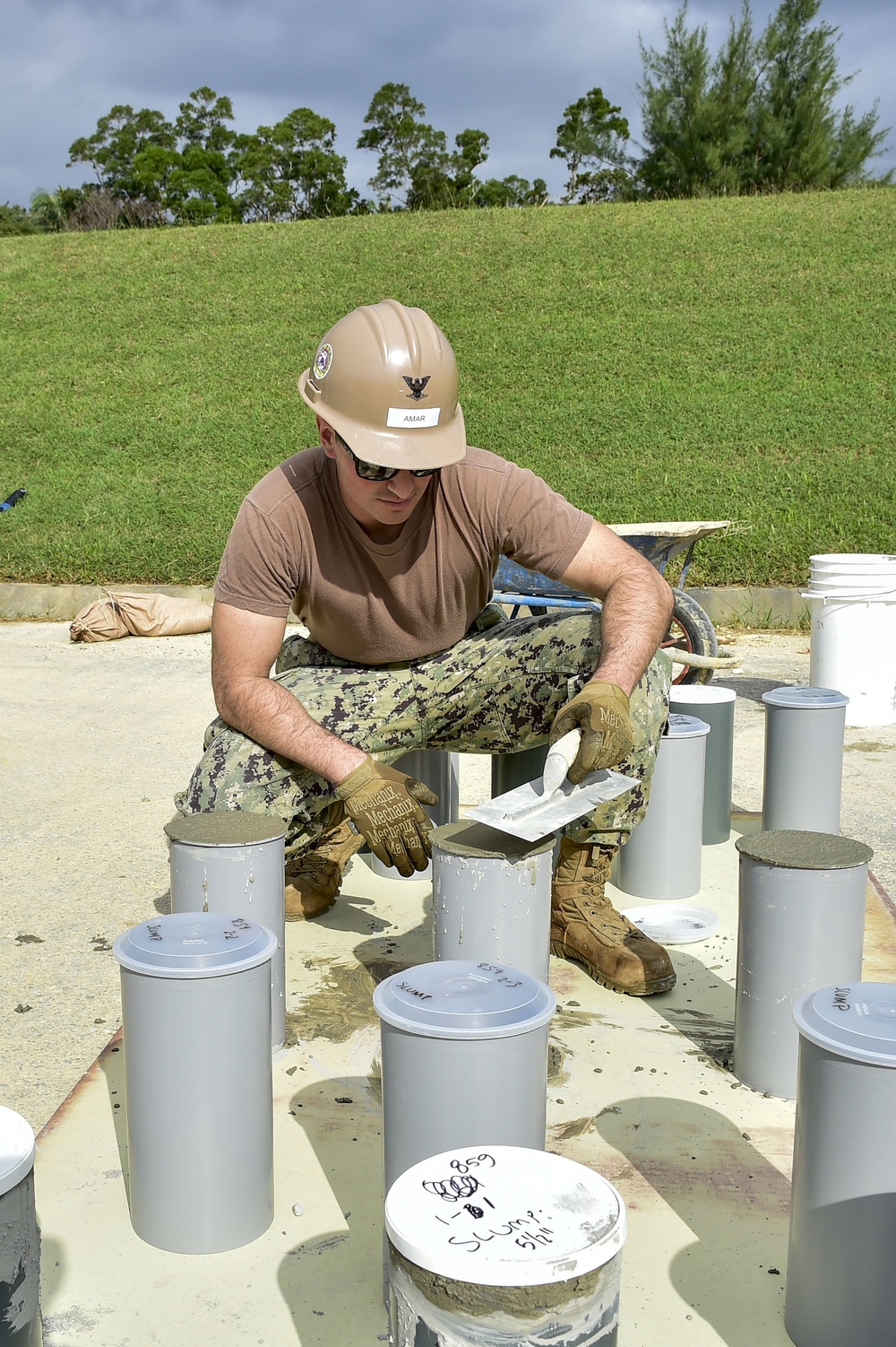 U.S. Navy Seabees with NMCB-5 place concrete at Camp Shields