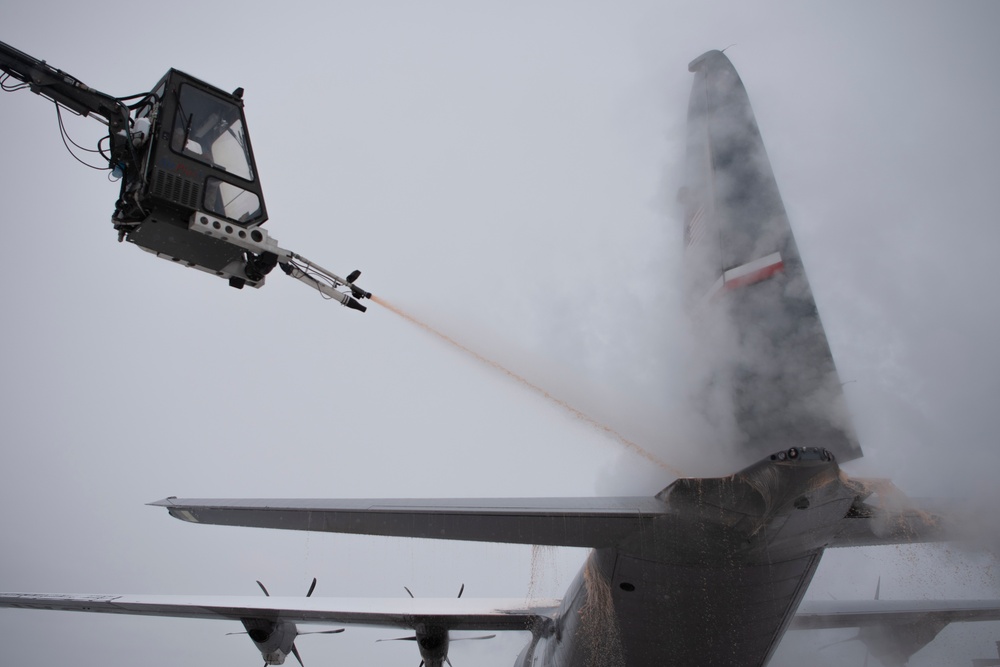 Hercules Airmen de-ice aircraft, re-ice each other