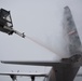 Hercules Airmen de-ice aircraft, re-ice each other