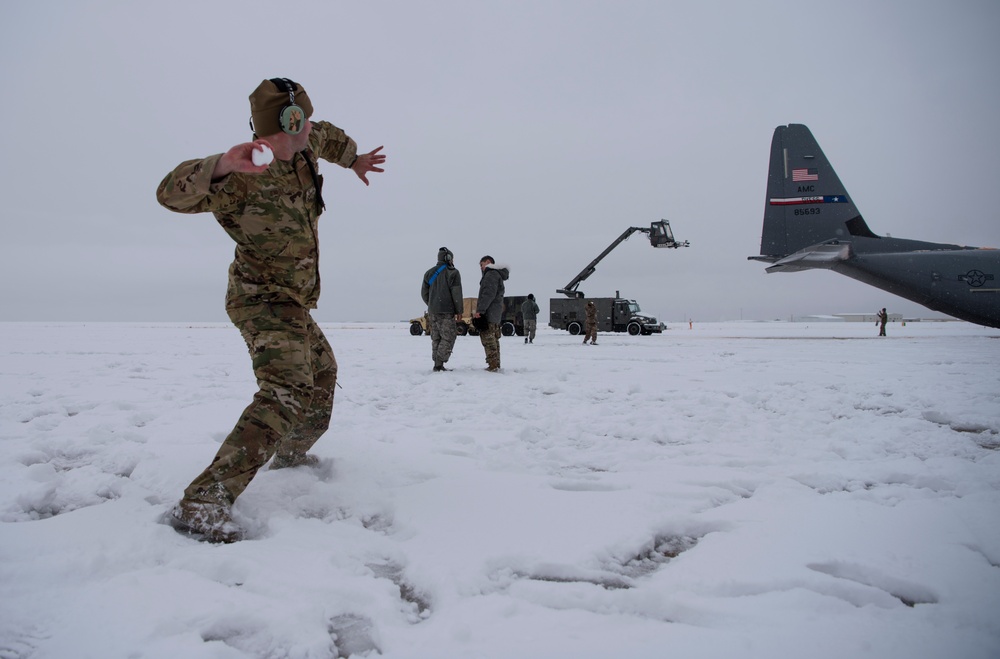 Hercules Airmen de-ice aircraft, re-ice each other