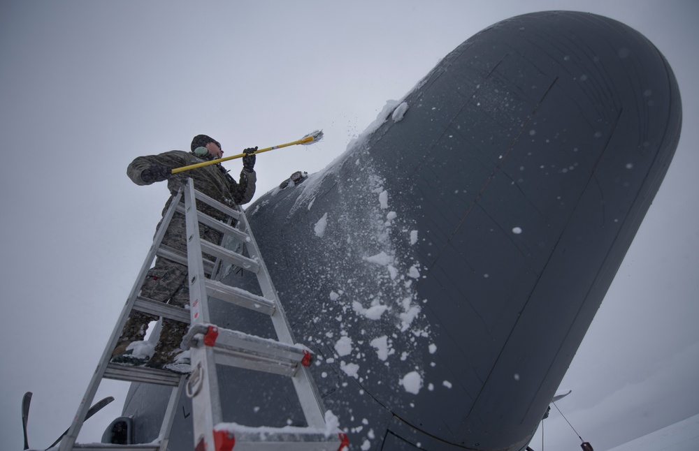 Hercules Airmen de-ice aircraft, re-ice each other