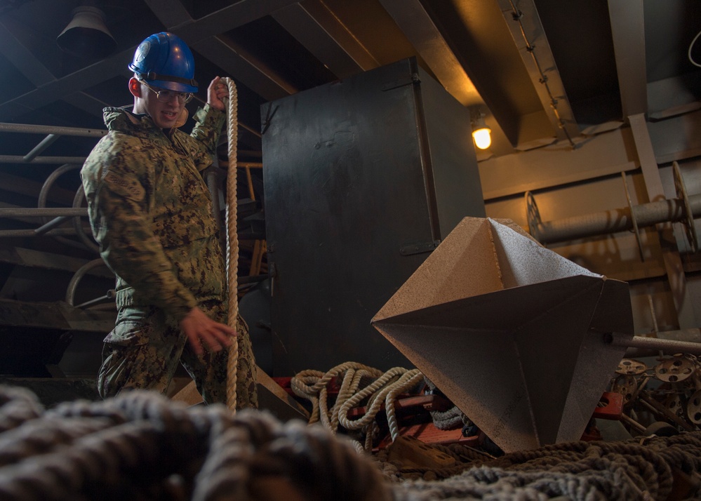 GHWB Sailor Maintains Rigging Lines