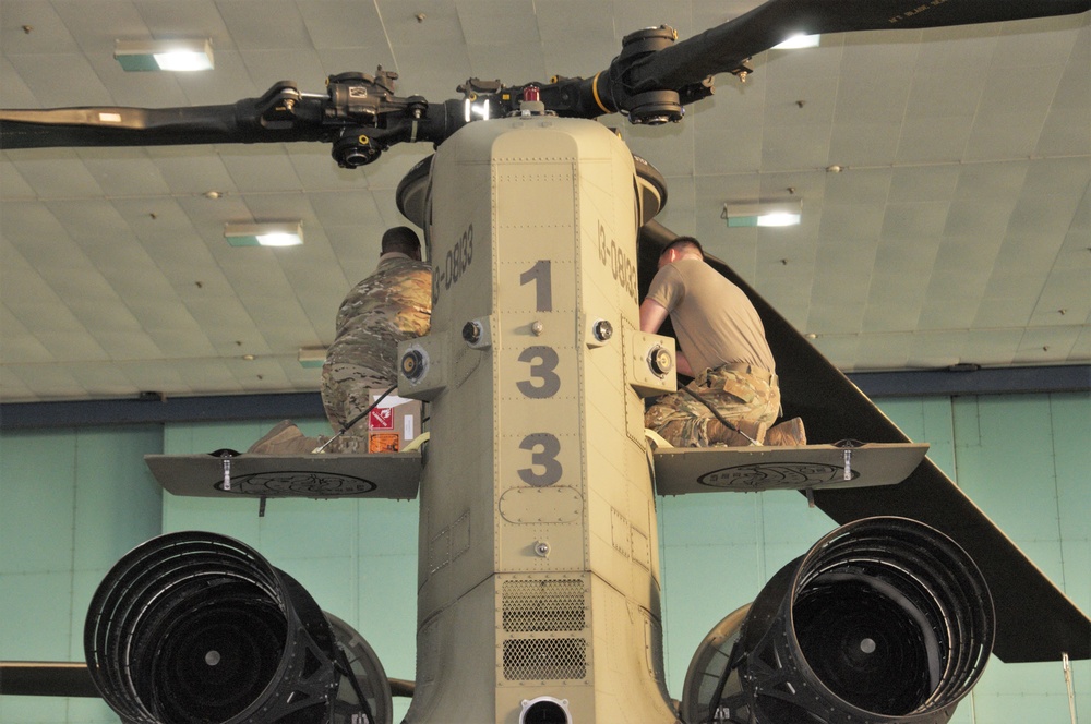 Soldiers pull maintenance on a Chinook.