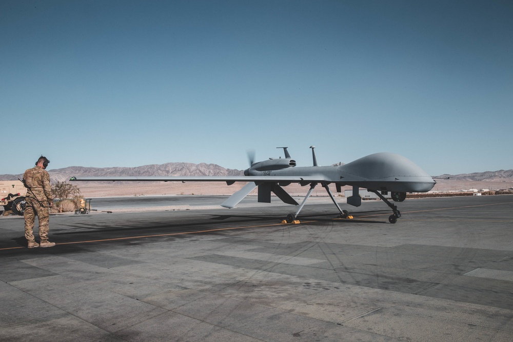 A Soldier operating an MQ-1C Gray Eagle prepares for takeoff at the Air Combat Element landing strip