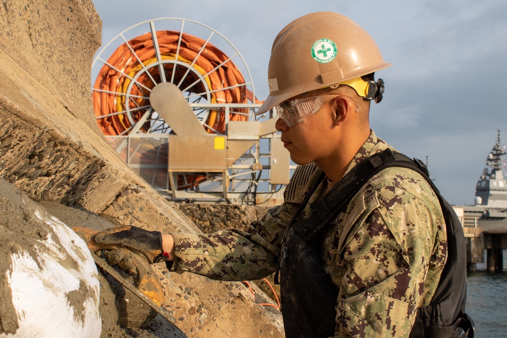 U.S. Navy Seabees deployed with Naval Mobile Construction Battalion 5’s Detail Sasebo work on the seawall repair project on board Commander Fleet Activities Sasebo