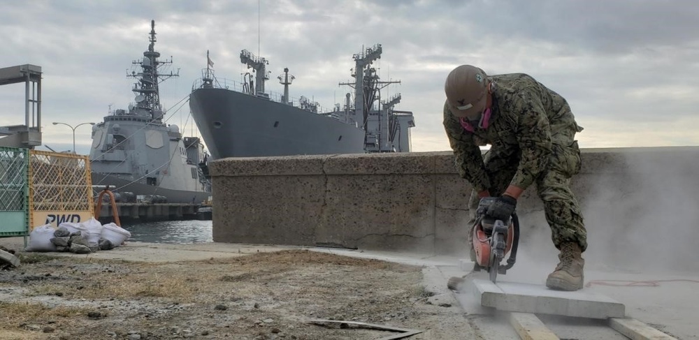 U.S. Navy Seabees deployed with Naval Mobile Construction Battalion 5’s Detail Sasebo work on the seawall repair project on board Commander Fleet Activities Sasebo