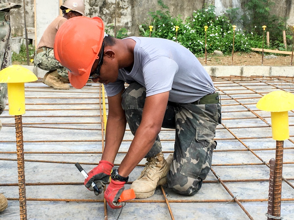 U.S. Navy Seabees deployed with NMCB-5’s Detail Palawan continue construction on Malatgao Elementary School
