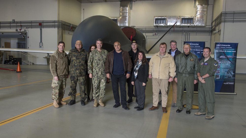 Capt. Kevin Pickard, commander, Naval Air Station (NAS) Sigonella, left center, and Lt. Col. Douglas Pruitt, executive officer, 7th Reconnaissance Squadron, far right, pose for a photo with a delegation from Bulgaria onboard NAS Sigonella.