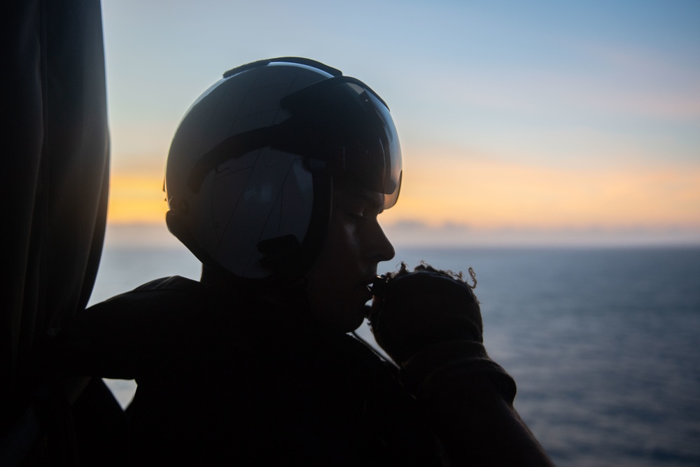 U.S. Navy Air Crewman monitors flight activity