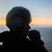 U.S. Navy Air Crewman monitors flight activity