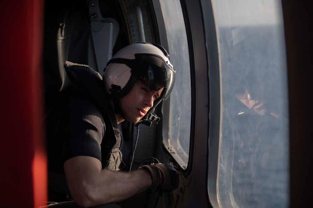 U.S. Navy Air Crewman prepares to land