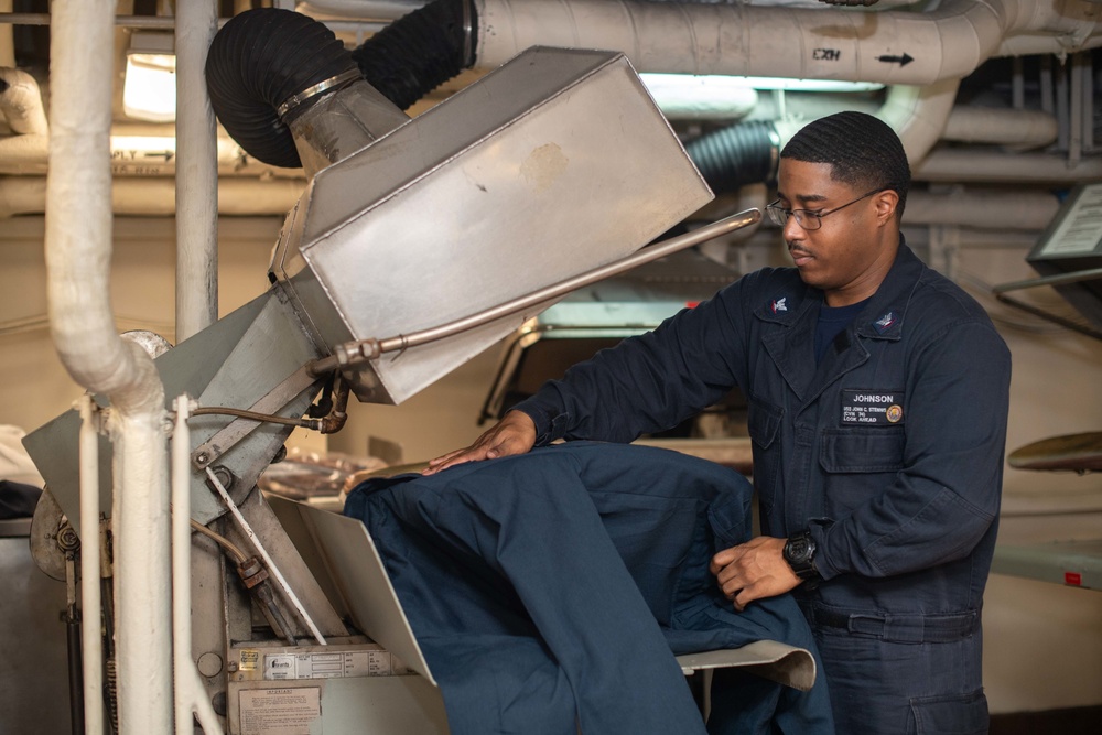 U.S. Sailor presses coveralls