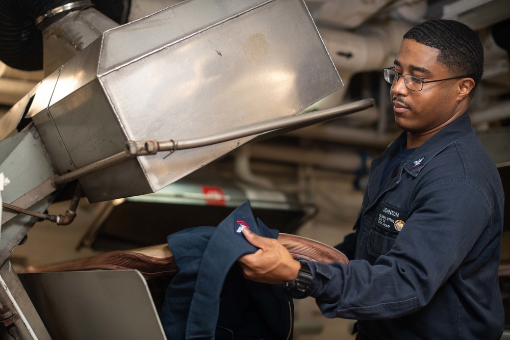 U.S. Sailor presses coveralls