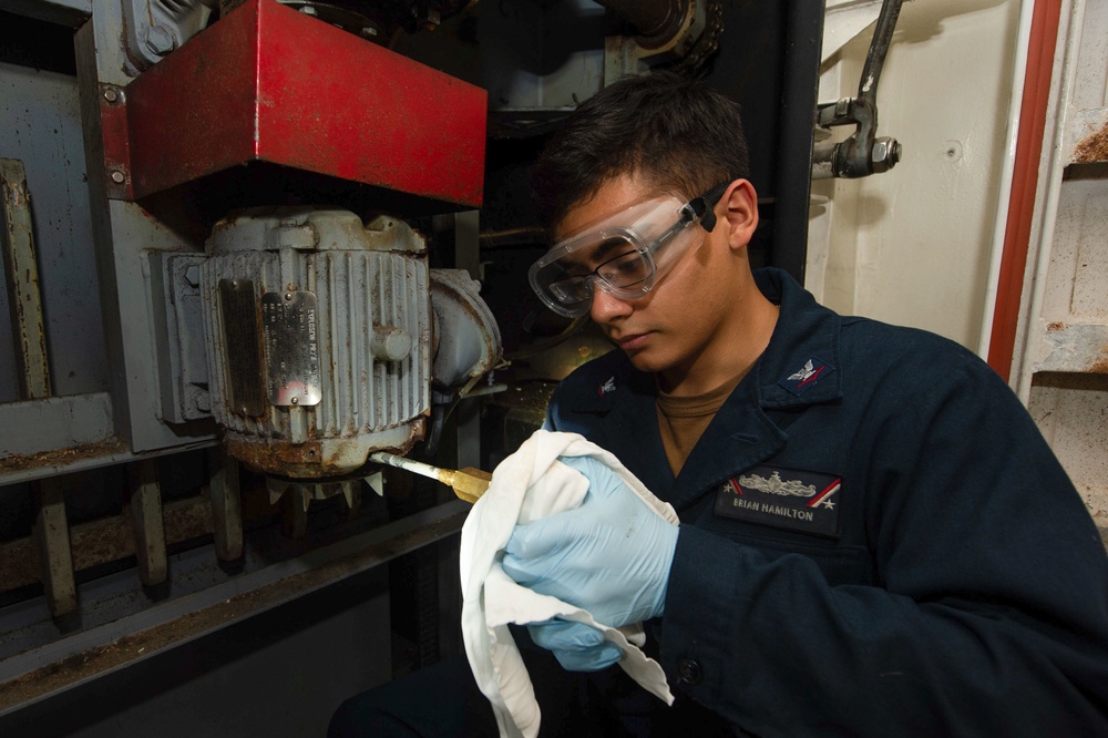 A Sailor conducts maintenance