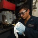 A Sailor conducts maintenance