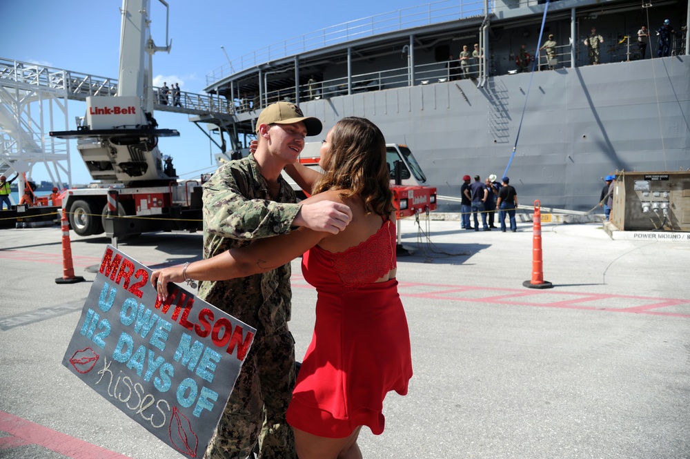 Machinery Repairman 2nd Class Tyler Wilson, from Syracuse, New York, assigned to the submarine tender USS Emory S. Land (AS 39), reunites with his wife during a homecoming gathering.