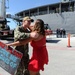 Machinery Repairman 2nd Class Tyler Wilson, from Syracuse, New York, assigned to the submarine tender USS Emory S. Land (AS 39), reunites with his wife during a homecoming gathering.