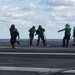 U.S. Sailors change an arresting gear wire