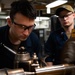 U.S. Sailors operate lathe