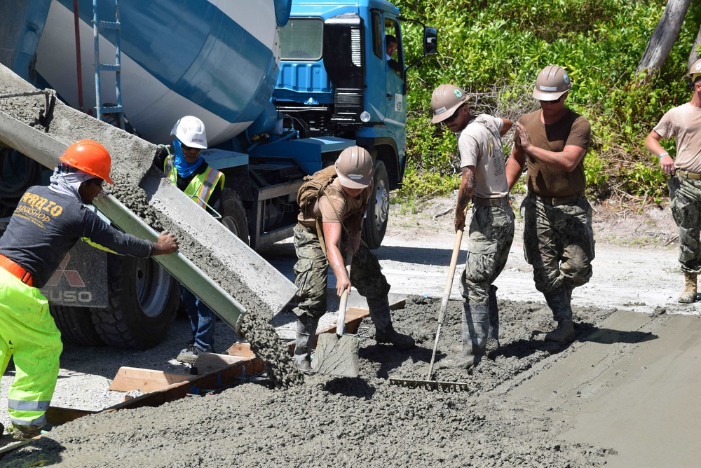 U.S. Navy Seabees from NMCB 5’s Detail Diego Garcia place concrete in support of the U.S. Air Force