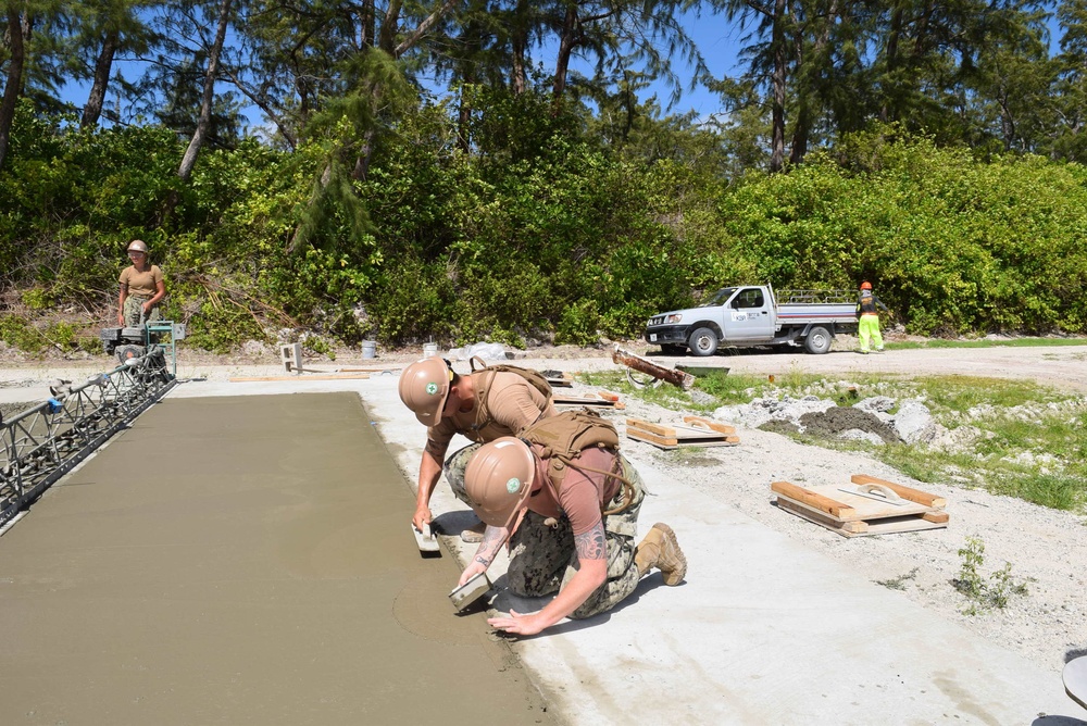 U.S. Navy Seabees from NMCB 5’s Detail Diego Garcia place concrete in support of the U.S. Air Force