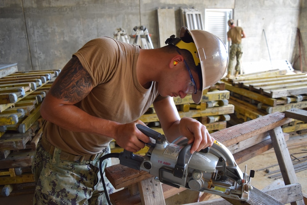 U.S. Navy Seabees deployed with NMCB-5’s Detail Tinian continue work on Explosive Ordnance Disposal Mobile Unit 5’s Boat Storage Facility