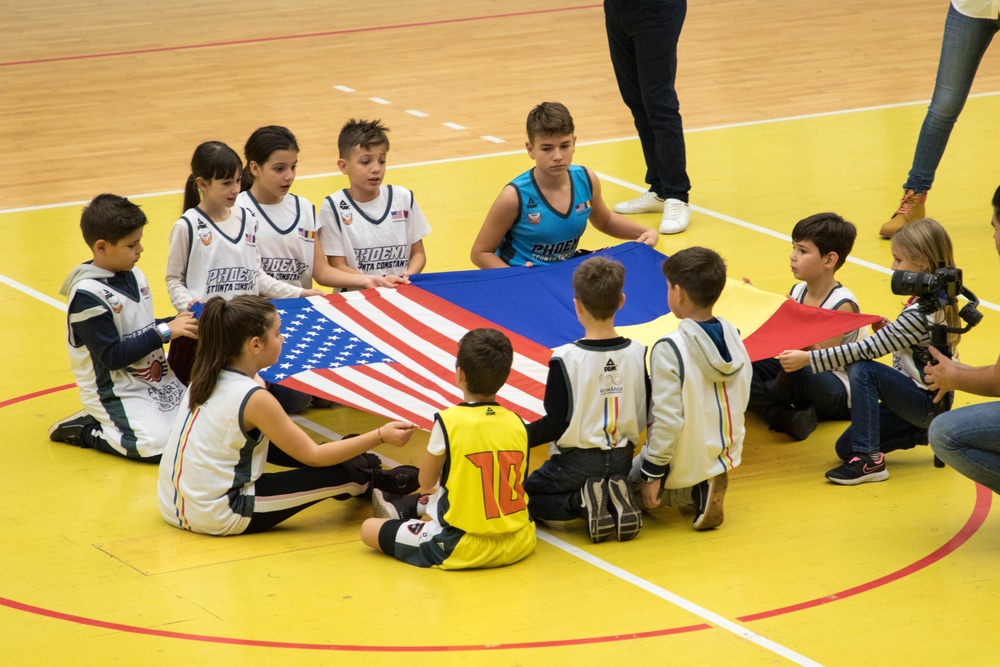 MKAB service members compete in a charity basketball game in Romania