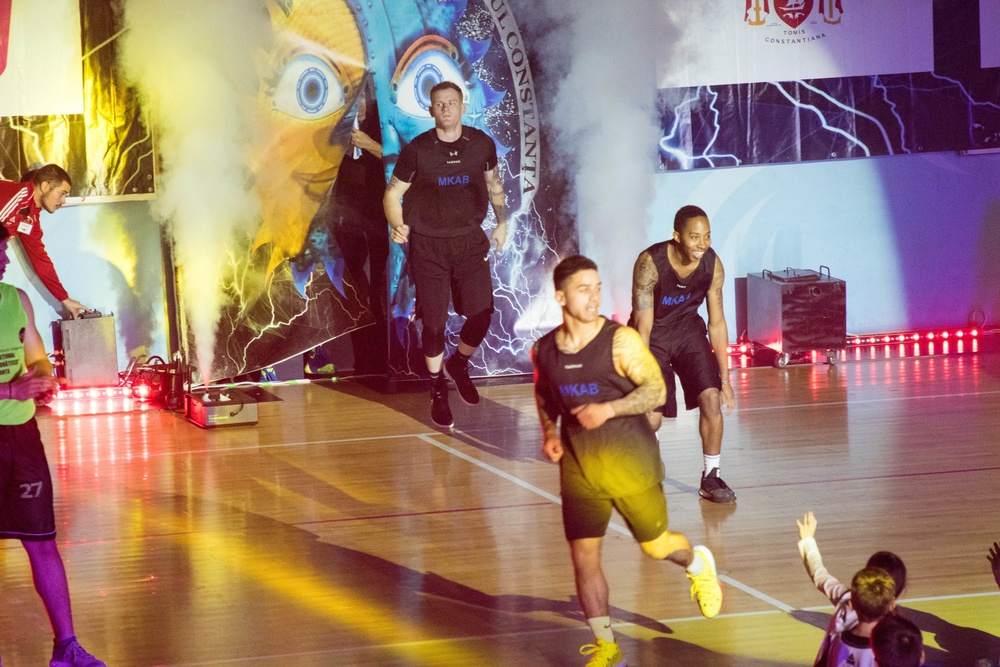 MKAB service members compete in a charity basketball game in Romania