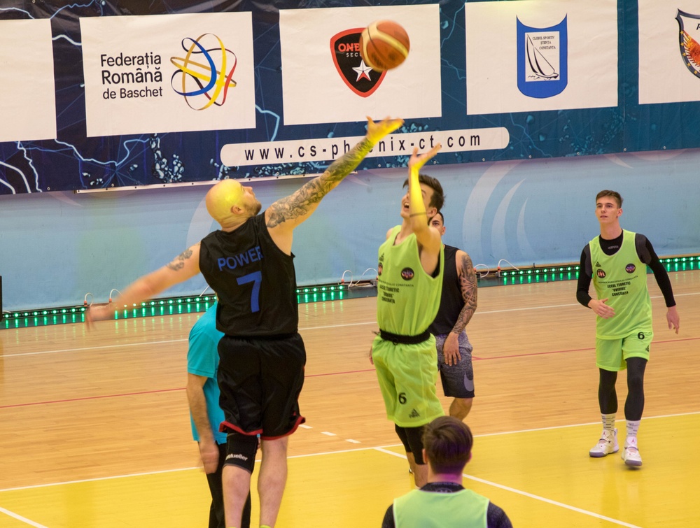 MKAB service members compete in a charity basketball game in Romania