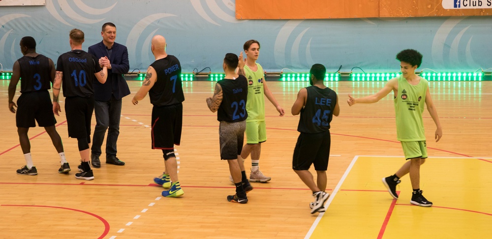 MKAB service members compete in a charity basketball game in Romania