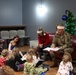 CG reads to children through the USO