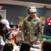 CG reads to children through the USO