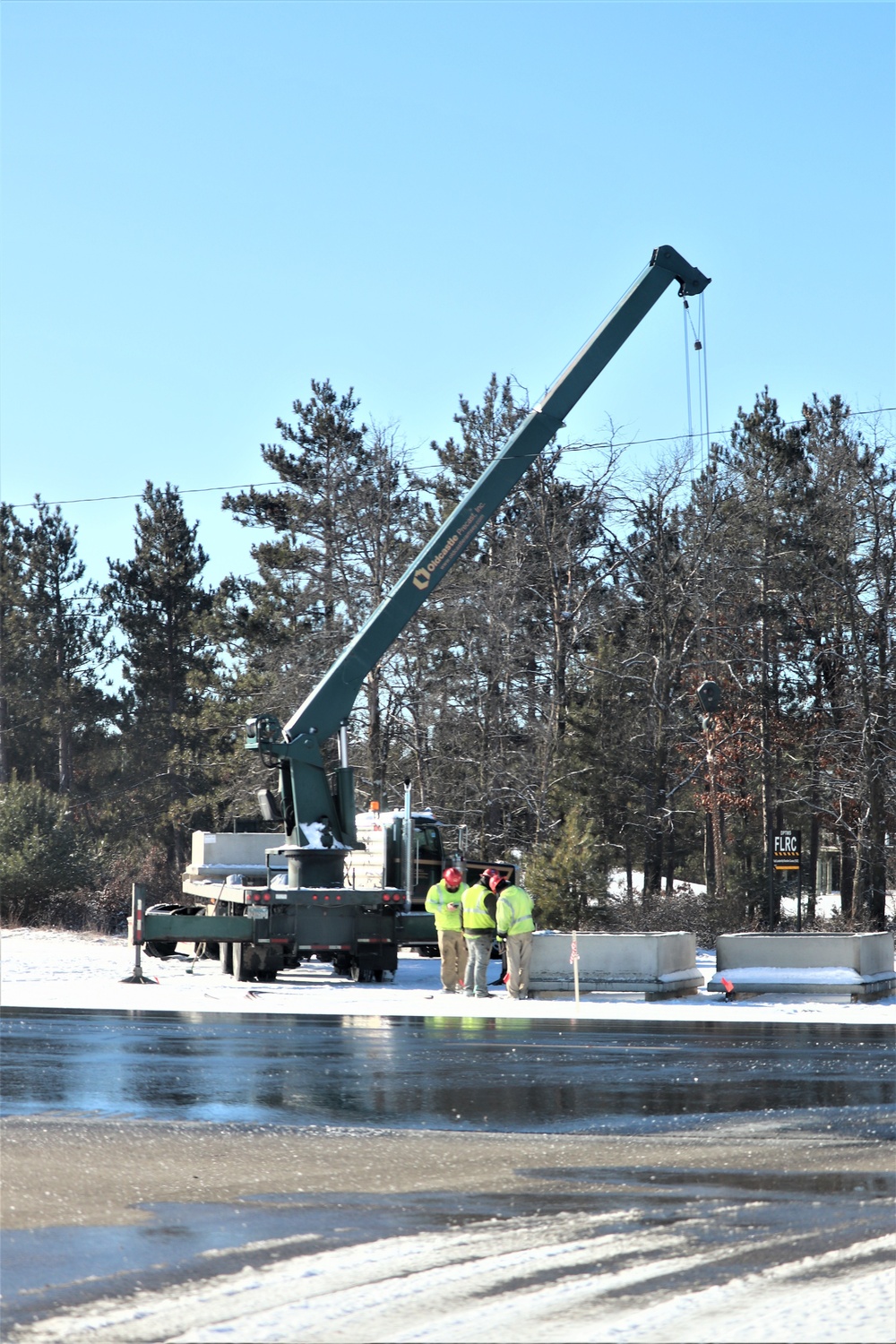 Contractors move concrete footings at Fort McCoy