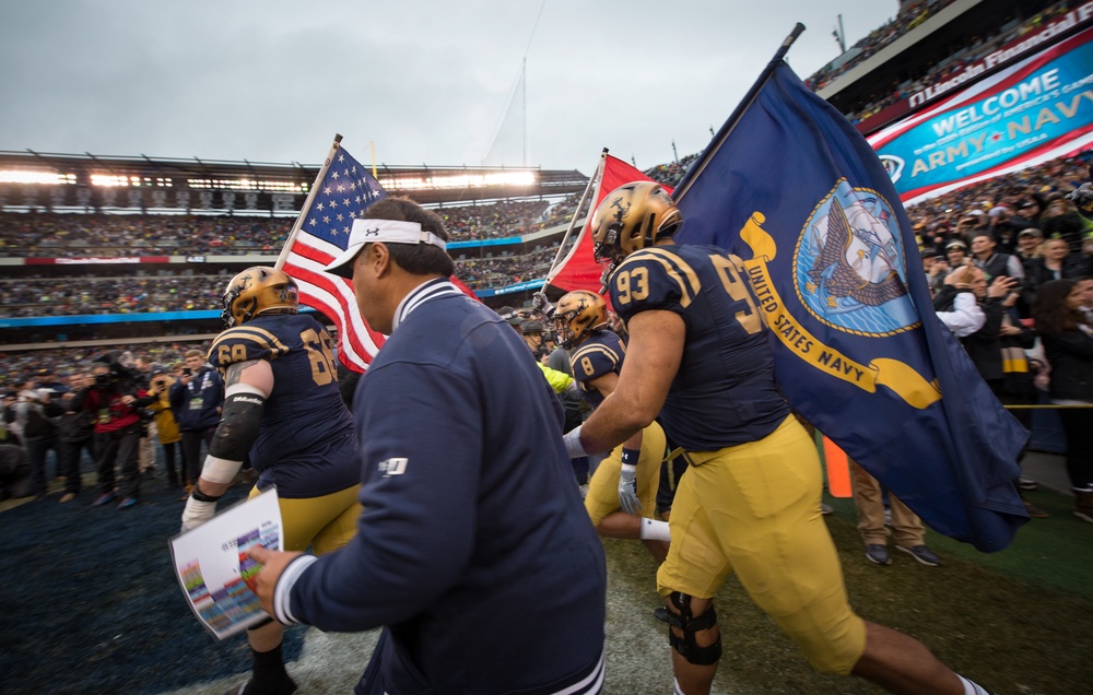 Army-Navy Game: U.S. Naval Academy Midshipmen run onto the field