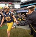 Army-Navy Game: U.S. Naval Academy Midshipmen run onto the field