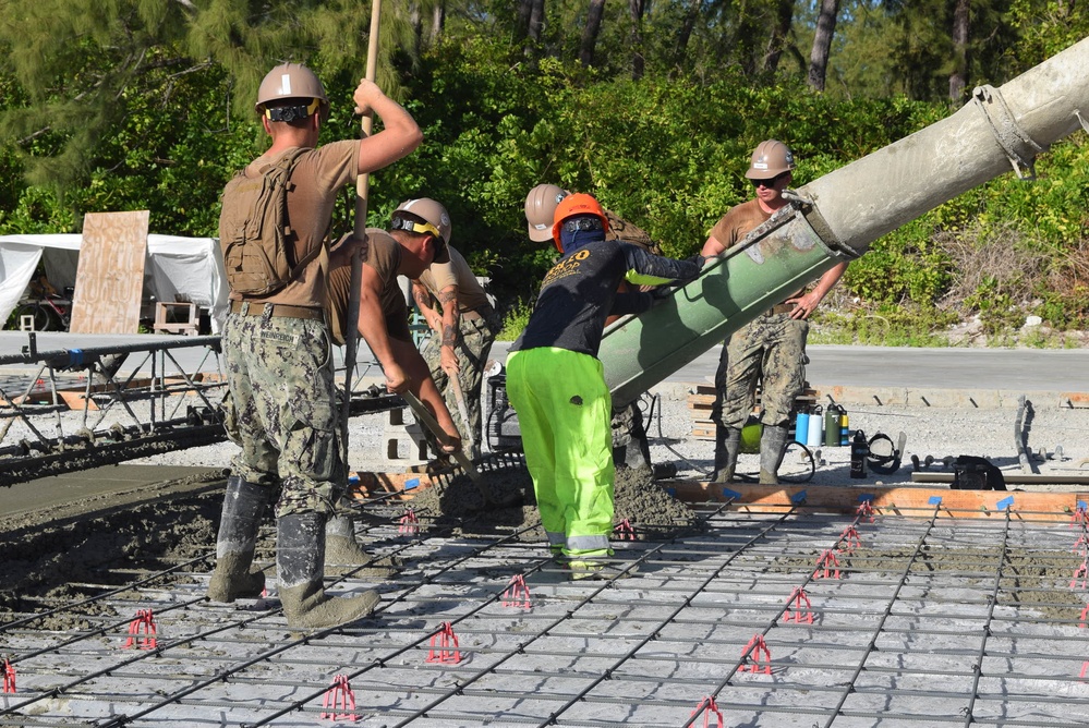 U.S. Navy Seabees from NMCB 5’s Detail Diego Garcia place concrete in support of the U.S. Air Force