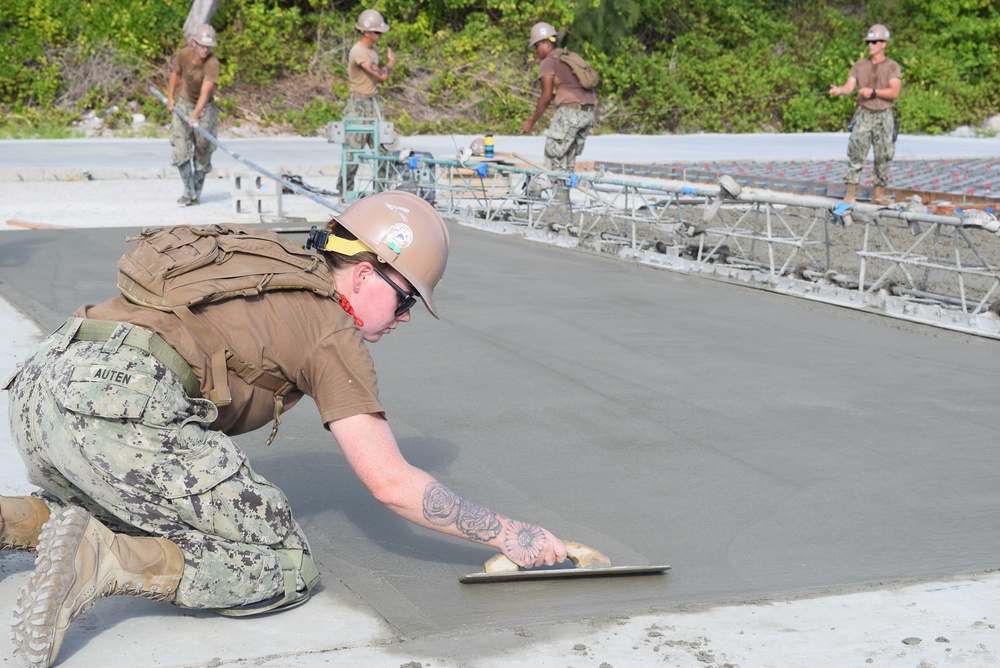 U.S. Navy Seabees from NMCB 5’s Detail Diego Garcia place concrete in support of the U.S. Air Force