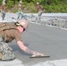 U.S. Navy Seabees from NMCB 5’s Detail Diego Garcia place concrete in support of the U.S. Air Force