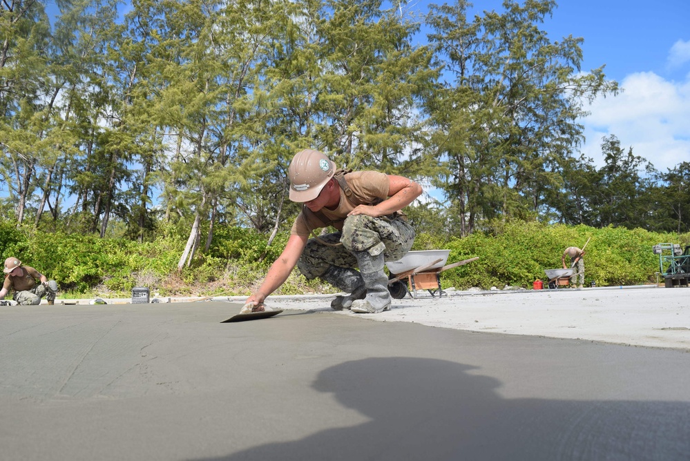 U.S. Navy Seabees from NMCB 5’s Detail Diego Garcia place concrete in support of the U.S. Air Force