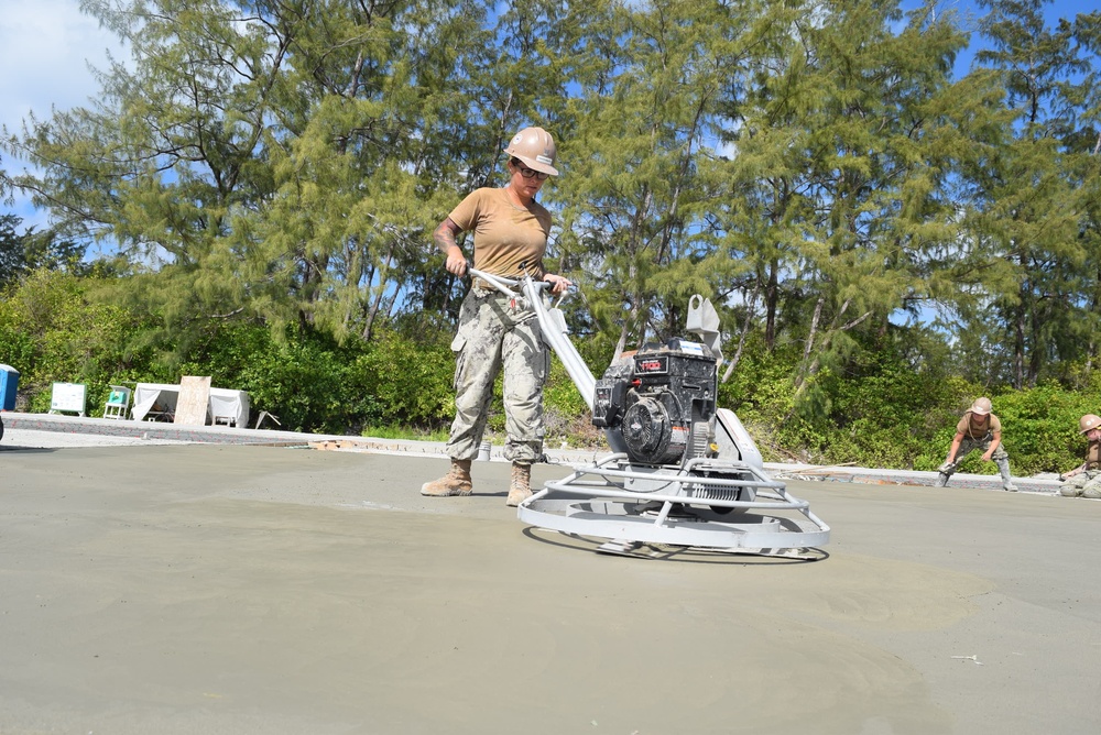 U.S. Navy Seabees from NMCB 5’s Detail Diego Garcia place concrete in support of the U.S. Air Force