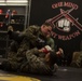 Professional mixed martial artist critique Marines during a Marine Corps Martial Arts Program Instructors Course