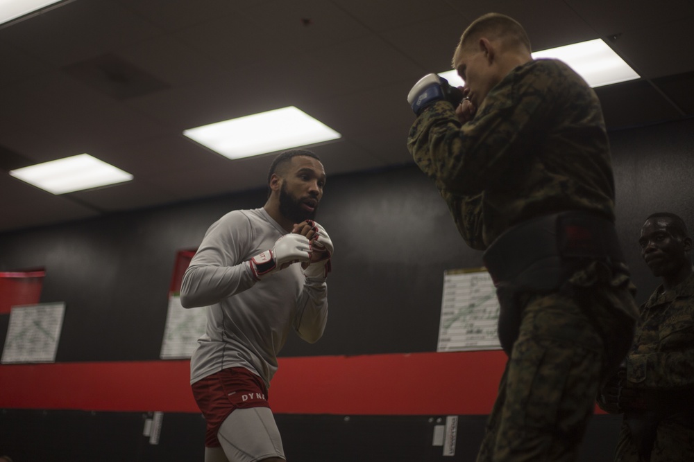 Professional mixed martial artist critique Marines during a Marine Corps Martial Arts Program Instructors Course