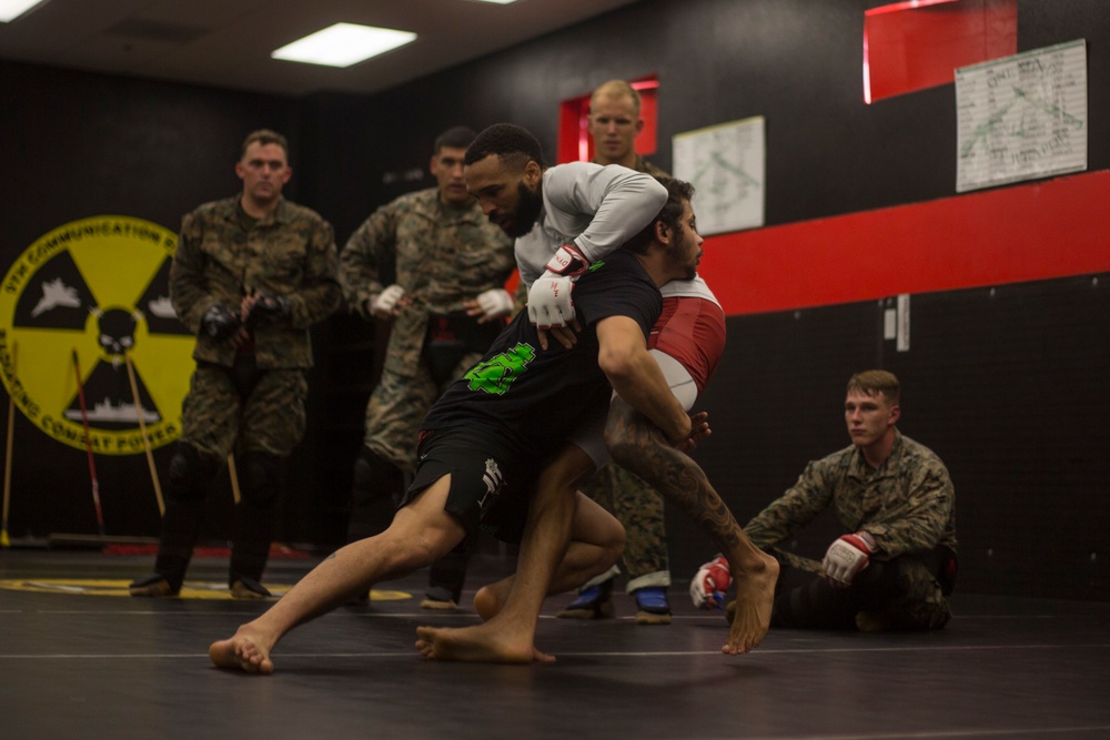 Professional mixed martial artist critique Marines during a Marine Corps Martial Arts Program Instructors Course