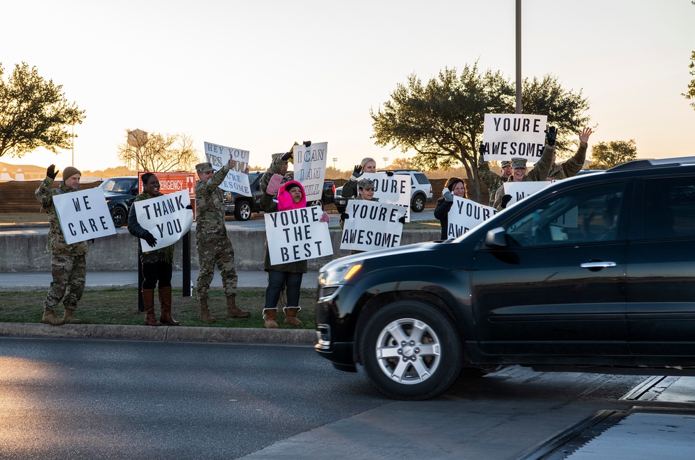 Volunteers show commuters ‘We Care’ at JBSA-Lackland entry gates