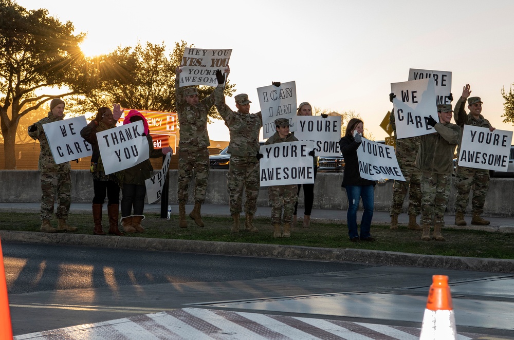 Volunteers show commuters ‘We Care’ at JBSA-Lackland entry gates