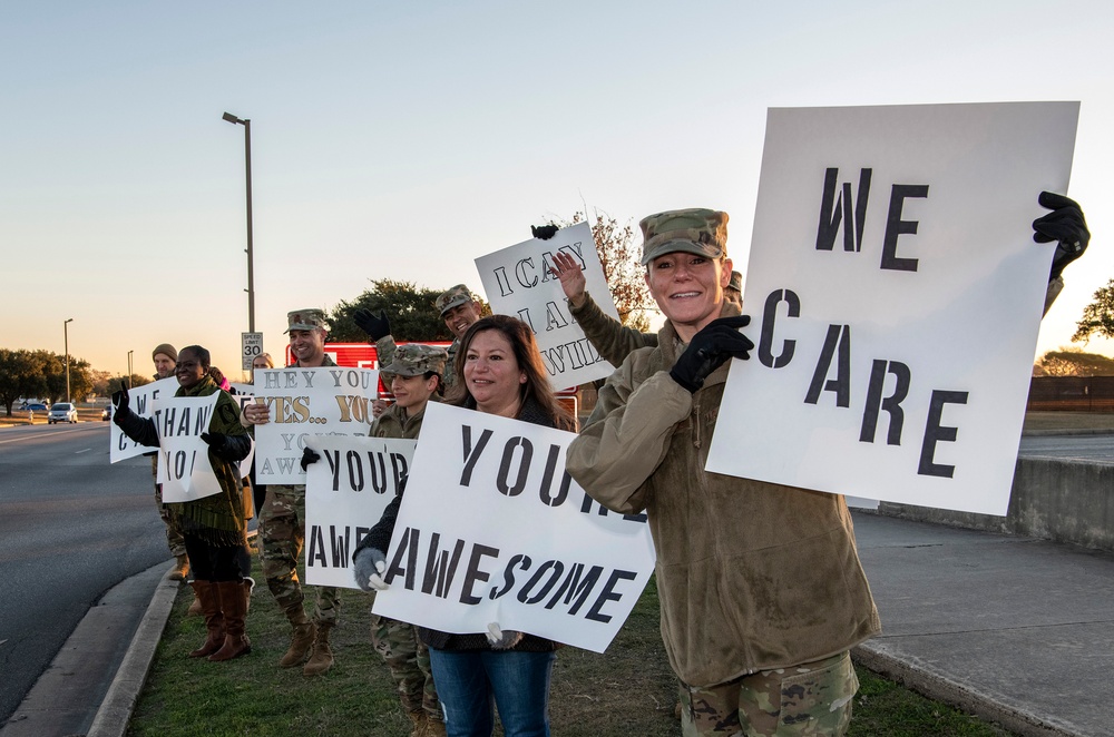 Volunteers show commuters ‘We Care’ at JBSA-Lackland entry gates