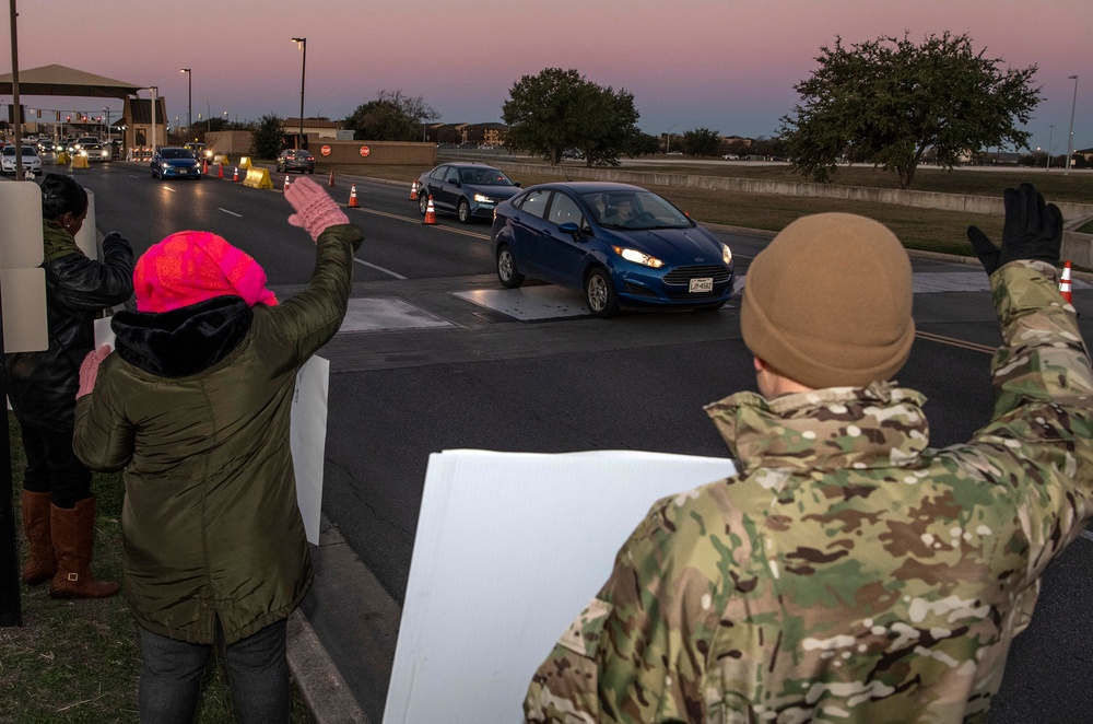 Volunteers show commuters ‘We Care’ at JBSA-Lackland entry gates